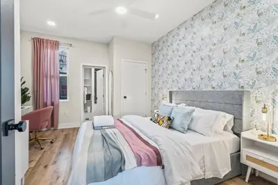 a bedroom with a large bed and a desk at Passyunk Square Spacious 1 BR Oasis- Huge Deck in Philadelphia
