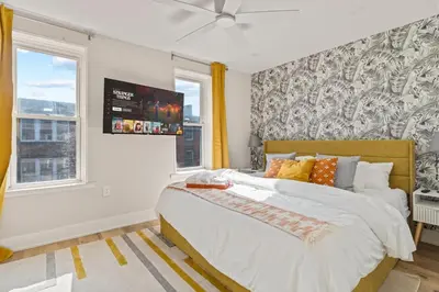 a bedroom with a large bed and a window at E Passyunk Ave 1 BR Gem - Prime Location! in Philadelphia