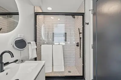 a bathroom with a shower and a sink and a mirror at E Passyunk Ave 1 BR Gem - Prime Location! in Philadelphia