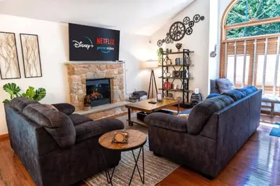 a living room with two couches and a fireplace at Serenity Falls - Stylish 4Bdr Mountain Retreat, Hot Tub, Pool in East Stroudsburg
