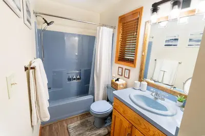 a bathroom with a sink and a toilet and a shower at Serenity Falls - Stylish 4Bdr Mountain Retreat, Hot Tub, Pool in East Stroudsburg