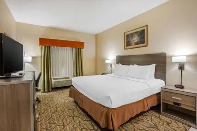 a hotel room with a bed and a flat screen tv at Best Western Danville Inn in Danville
