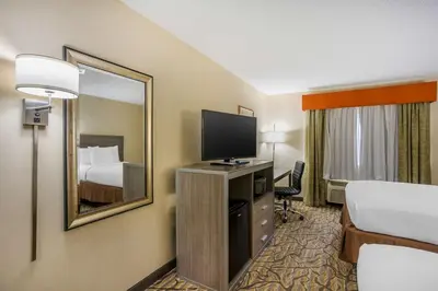 a hotel room with a bed and a flat screen tv at Best Western Danville Inn in Danville