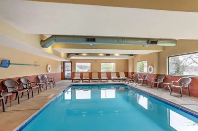 a swimming pool with chairs and tables and a pool at Best Western Danville Inn in Danville