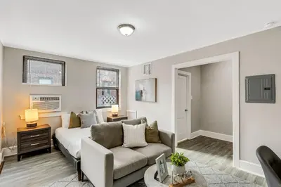 a living room with a couch and a table at Lennox C201 Furnished Studio ATT Students in Philadelphia