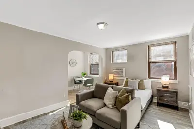 a living room with a couch and a table at Lennox C201 Furnished Studio ATT Students in Philadelphia