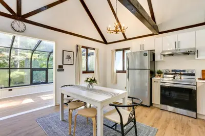 a kitchen with a white table and chairs at Glen Spey Cabin with Deck 1 Mi to Mohican Lake! in Glen Spey