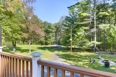 a deck with a view of a yard with trees at Glen Spey Cabin with Deck 1 Mi to Mohican Lake! in Glen Spey