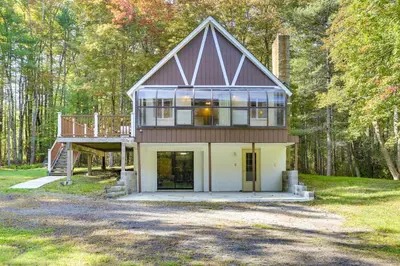 a house in the middle of a forest at Glen Spey Cabin with Deck 1 Mi to Mohican Lake! in Glen Spey