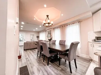 a dining room and kitchen with a table and chairs at Cheerful & Modern Home w/ a Walkout Deck Area in Glenside
