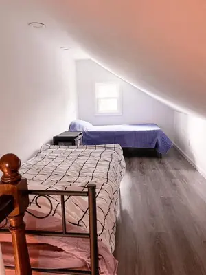 a bedroom with two beds and a window at Cheerful & Modern Home w/ a Walkout Deck Area in Glenside