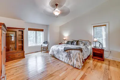 a bedroom with a bed and a wooden floor at 2 Mi to Elk Mountain Secluded Union Dale Home! in Pleasant Mount