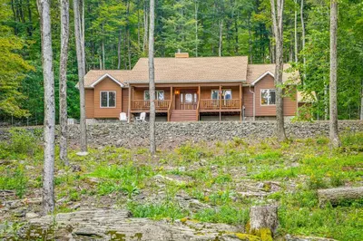 a log cabin in the woods with trees at 2 Mi to Elk Mountain Secluded Union Dale Home! in Pleasant Mount