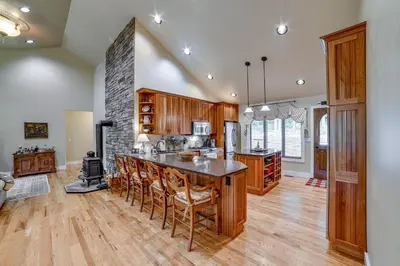 a kitchen with a table and chairs and a stove at 2 Mi to Elk Mountain Secluded Union Dale Home! in Pleasant Mount