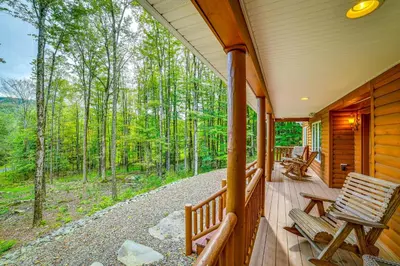 a porch of a cabin with chairs and a view of the woods at 2 Mi to Elk Mountain Secluded Union Dale Home! in Pleasant Mount