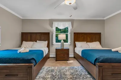 a bedroom with two beds and a window at Star Gazer Luxury A-Frame Wood Cabin. Near York/Harrisburg/Hershey/Lancaster in Goldsboro