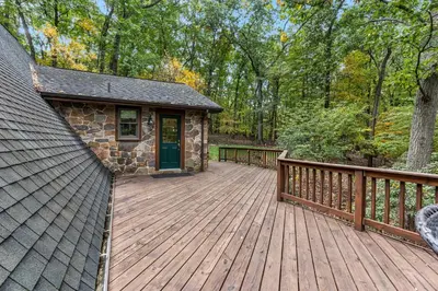 a large wooden deck with a building on it at Star Gazer Luxury A-Frame Wood Cabin. Near York/Harrisburg/Hershey/Lancaster in Goldsboro