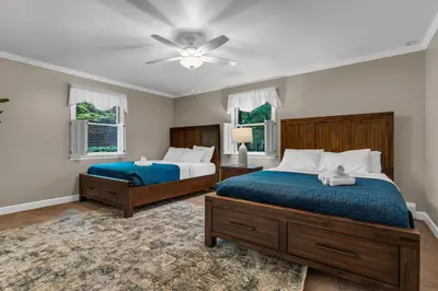 a bedroom with two beds and a ceiling fan at Star Gazer Luxury A-Frame Wood Cabin. Near York/Harrisburg/Hershey/Lancaster in Goldsboro