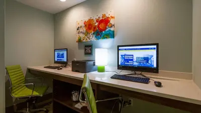 an office with two monitors and a computer on a desk at Best Western Plus Harrisburg Mechanicsburg in Enola