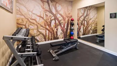 a fitness room with a mural of trees at Best Western Plus Harrisburg Mechanicsburg in Enola
