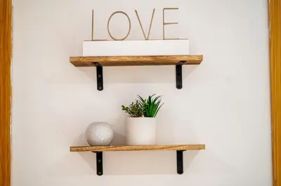 a shelf with love spelled out on a wall at Charming Home In Heart of City With King Size Bed! in Philadelphia