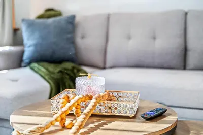 a table with a candle and a remote control at Charming Home In Heart of City With King Size Bed! in Philadelphia