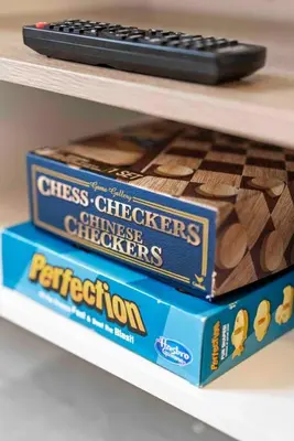 two boxes of chocolates and a remote control on a shelf at Contemporary Luxury BR, EWR AIRPT, Nyc, Free Pkng, Prudential CNTR, American Dream Mall in Elizabeth