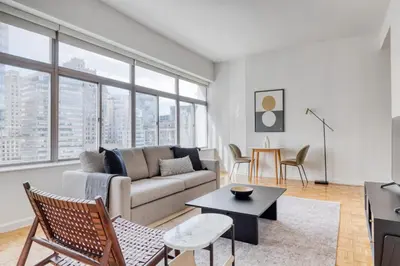 a living room with a couch and a table at FiDi 2BR w Elevator Gym Doorman nr Wall St NYC-661 in New York