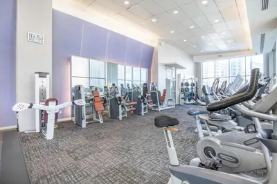 a gym with treadmills and cardio equipment in a building at FiDi 2BR w Elevator Gym Doorman nr Wall St NYC-661 in New York