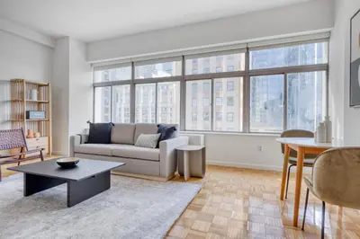 a living room with a couch and a table at FiDi 2BR w Elevator Gym Doorman nr Wall St NYC-661 in New York