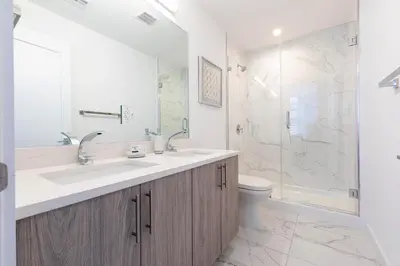 a bathroom with a sink and a toilet and a shower at Modern 3BR Lofts with Outdoor Space Near NYC in Hoboken