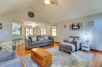 a living room with two couches and a table at Hot Tub, Deck and Game Room Spacious Poconos Escape in Stroudsburg