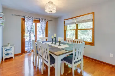 a dining room with a table and chairs at Hot Tub, Deck and Game Room Spacious Poconos Escape in Stroudsburg