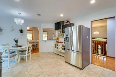 a kitchen and dining room with a stainless steel refrigerator at Hot Tub, Deck and Game Room Spacious Poconos Escape in Stroudsburg