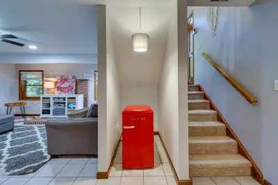 a red mailbox in a living room with a staircase at Hot Tub, Deck and Game Room Spacious Poconos Escape in Stroudsburg