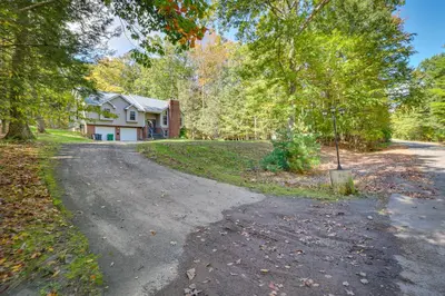 an empty road in front of a house at Hot Tub, Deck and Game Room Spacious Poconos Escape in Stroudsburg