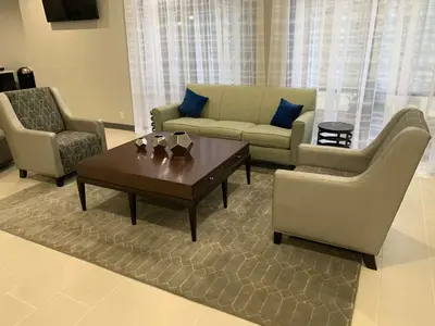 a living room with couches and a coffee table at Best Western Plus Clarks Summit Scranton Hotel in Clarks Summit