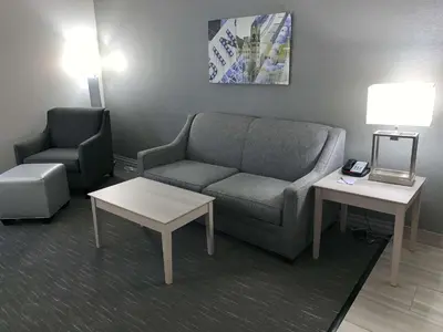 a living room with a couch and a chair at Best Western Plus Clarks Summit Scranton Hotel in Clarks Summit