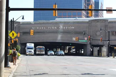 a bridge over a city street with cars and buses at Cozy & Deluxe Apartment - EZ Access to NYC in Newark