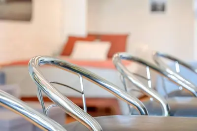 a group of chairs with a table in a room at Cool Urban Stay Dtwn Apt And Patio in Binghamton