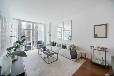 a living room with a couch and a table at Times Square Penthouse in New York