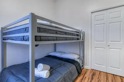 a bedroom with a bunk bed with two pillows at Gorgeous Duplex with parking by JSQ in Jersey City