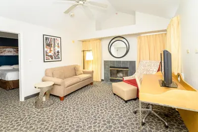 a living room with a couch a chair and a television at Philadelphia Suites at Airport - An Extended Stay Hotel in Philadelphia