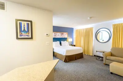 a hotel room with a bed and a couch at Philadelphia Suites at Airport - An Extended Stay Hotel in Philadelphia