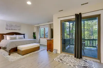 a bedroom with a bed and a sliding glass door at Ski-InandSki-Out! Mountain Creek Resort Condo in Vernon Township