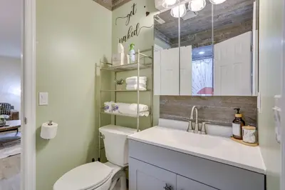 a bathroom with a toilet and a sink and a mirror at Ski-InandSki-Out! Mountain Creek Resort Condo in Vernon Township