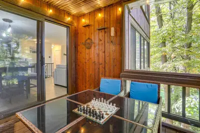 a room with a glass table and blue chairs at Ski-InandSki-Out! Mountain Creek Resort Condo in Vernon Township