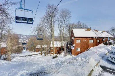 a ski lift above a house in the snow at Ski-InandSki-Out! Mountain Creek Resort Condo in Vernon Township