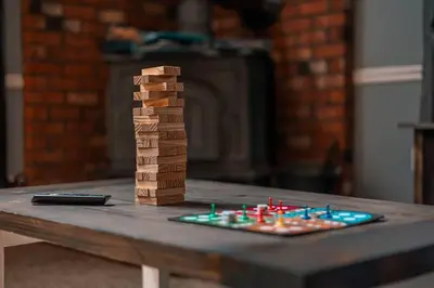 a group of wooden blocks on a table at Cheerful Chalet - Fireplace, BBQ, Firepit& Hottub in Long Pond