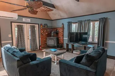 a living room with two couches and a television at Cheerful Chalet - Fireplace, BBQ, Firepit& Hottub in Long Pond